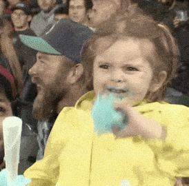 A kid eating blue cotton candy with a wild grin